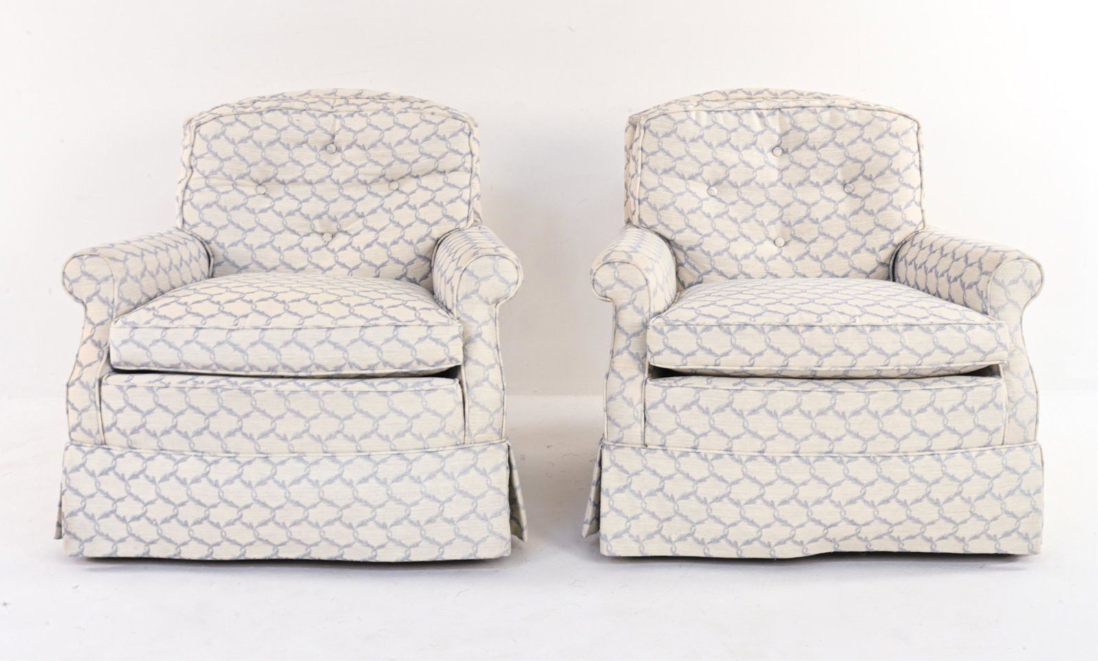 PAIR OF CONETMPORARY UPHOLSTERED LOUNGE CHAIRS: No apparent labels. Upholstered in fabric with light blue foliate interlace motif. Dimensions: H 32" x W 34" x D 30" x SH 18" Condition: Some areas of sun fading to fabric. Few small stains.