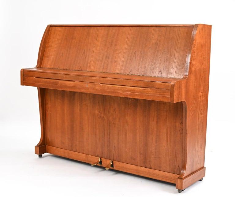KNUDSEN & SON DANISH MID-CENTURY TEAK PIANETTE: A rare mid-century Danish piano, made of beautiful teak. It is called a pianette because of its 82 keys rather than the standard 88 keys of a full-size piano. This piano is made by the famous piano ma