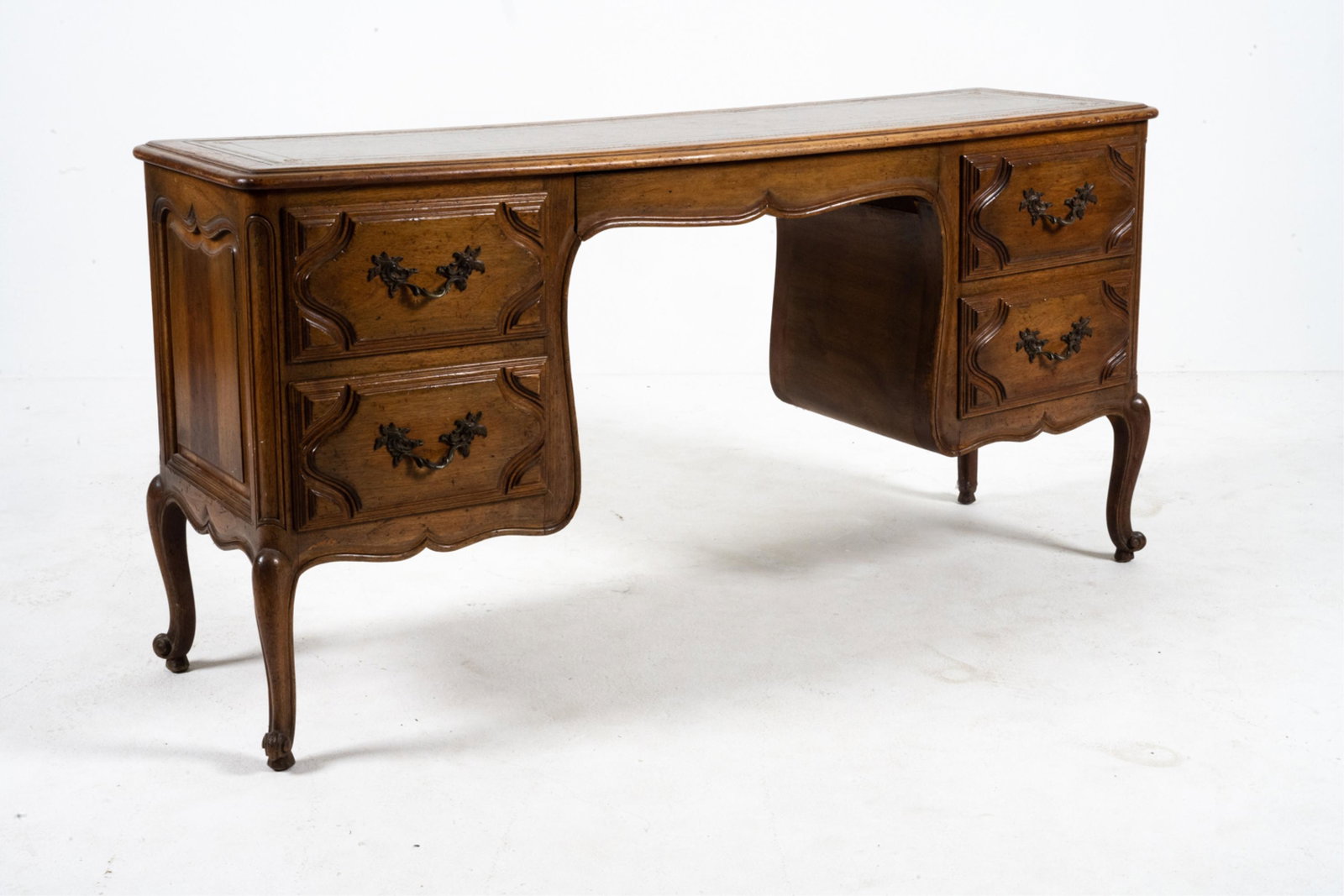 FRENCH LOUIS XV-STYLE LEATHER TOP DESK: Vintage, c. early 20th century. Carved wood with leather top. Dovetailed drawer joints. Dimensions: H 30" x W 61" x D 18" Condition: Wear consistent with age and use including some surface marks, nick