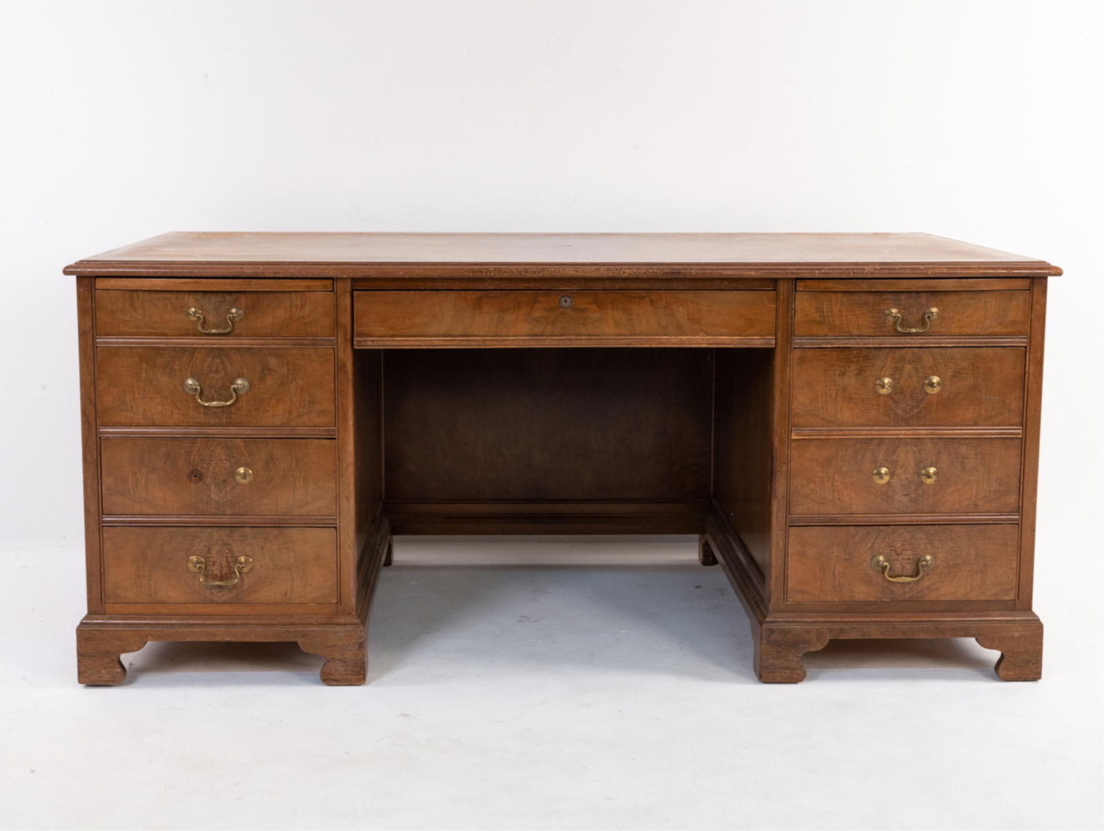 EARLY 20TH C. JASPER CO. BURLWOOD EXECUTIVE DESK: Dimensions: H 30.5" x W 69" x D 36" Condition: Great candidate for restoration; finish losses throughout; nicks and scuffs, gouges, a few water spots and spots of soiling, etc.