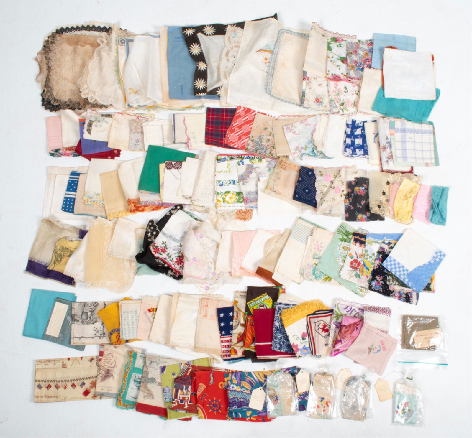 GROUPING OF ANTIQUE HANDKERCHIEFS & NEEDLEWORK: Including commemorative/souvenir handkerchiefs and scarves from World War I, the 1898 and 1939 World's Fairs, an 1898 production of the Strauss opera "The Queen's Lace Handkerchief", the Pendleton Rou