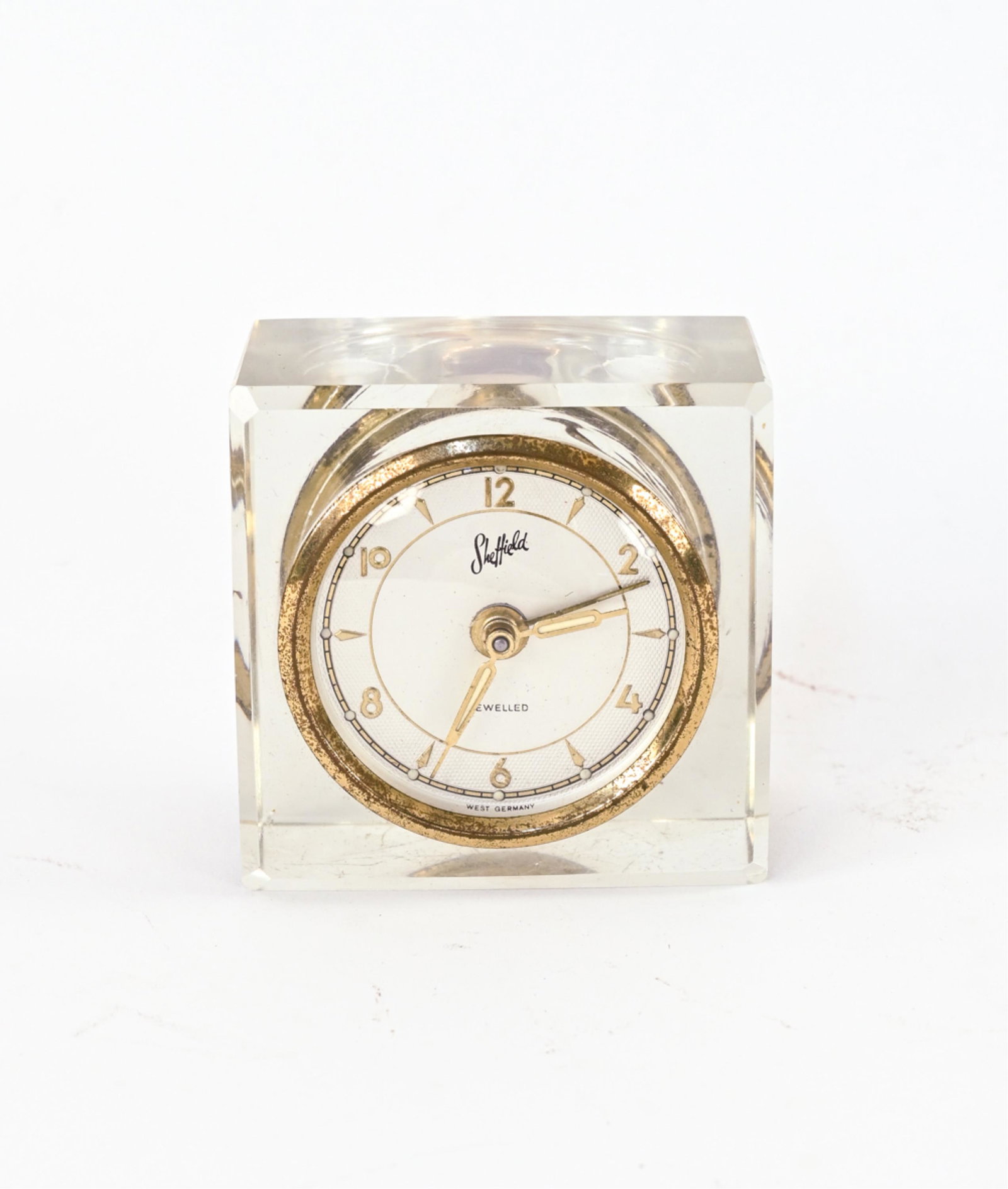 VINTAGE SHEFFIELD GLASS CASE DESK CLOCK: Dimensions: H 3" x W 3" x D 2.25" Condition: Not tested; movement not professionally inspected. A couple tiny flea bites to glass. Patina and finish loss to brass.