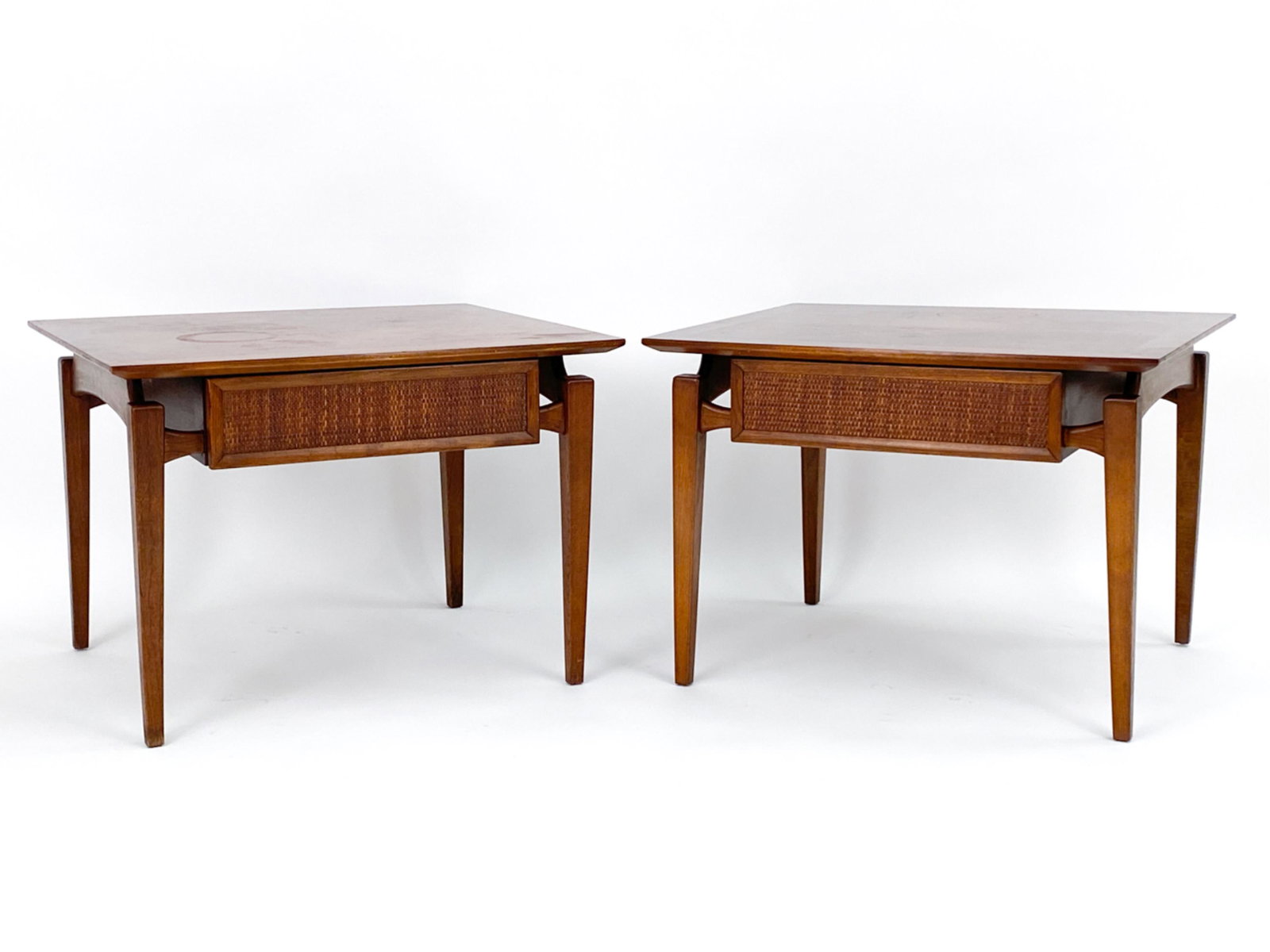 PAIR ANDRE BUS LANE "ESTEEM" END TABLES: (2) One drawer Lane floating side/end tables designed by Andre Bus as part of his "Esteem" line. Walnut and woven cane, C.1963. Signed in drawer and under. Dimensions: H 20" x W 25" x D 28" Condition: