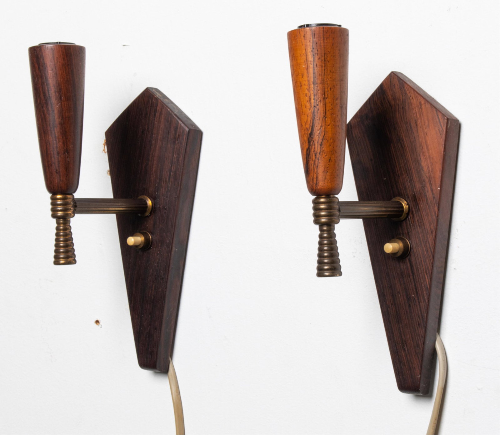 PAIR DANISH ROSEWOOD & BRASS SCONCES, C. 1960'S: Dimensions: H 8.5" x W 2.75" x D 4.5" Condition: Wiring not tested. A few small dings and scuffs, light surface tarnish and patination to brass. One sconce with very minor sun fading and a couple smal