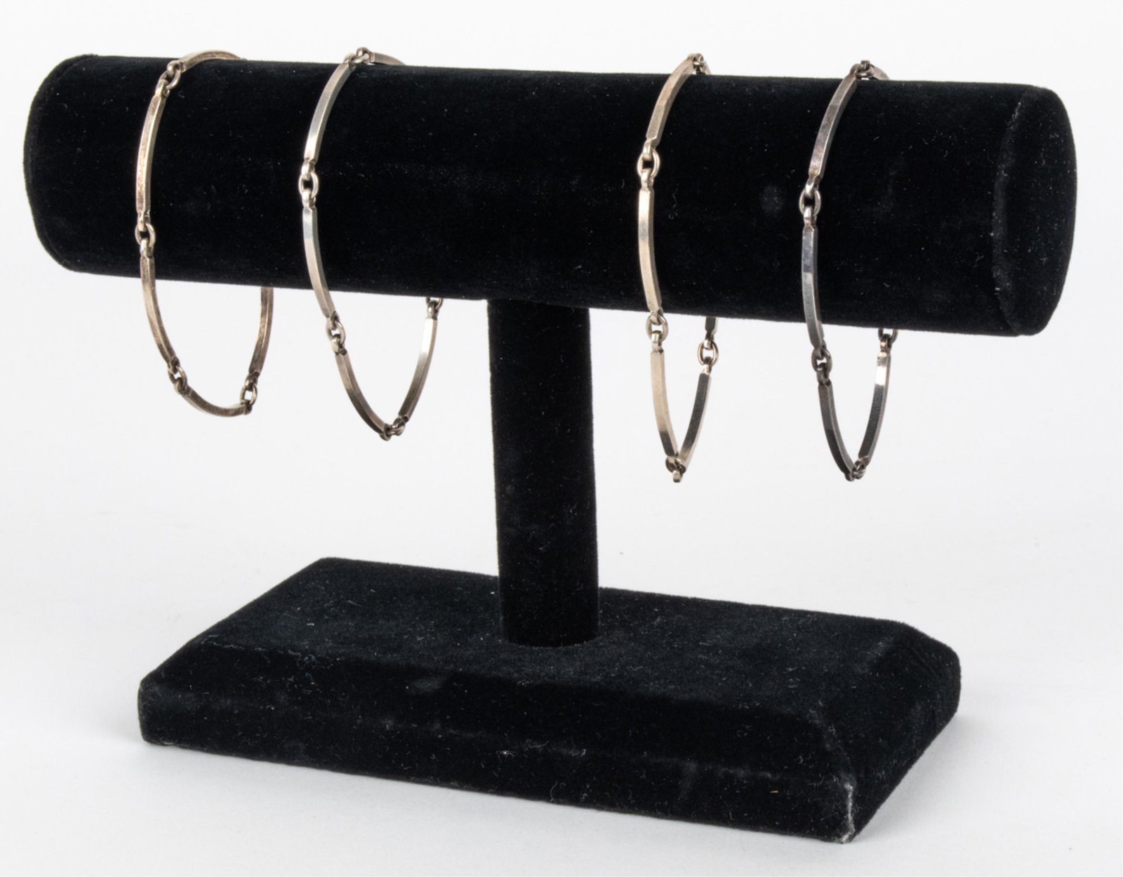 (4) NIELS ERIK FROM SILVER BAR LINK BRACELET: Grouping of (4) Danish Modernist bar-link bracelets in sterling silver, each signed and hallmarked Sterling on the last link. Dimensions: L 7.5" x W 0.0625" Condition: Light surface tarnish and patina