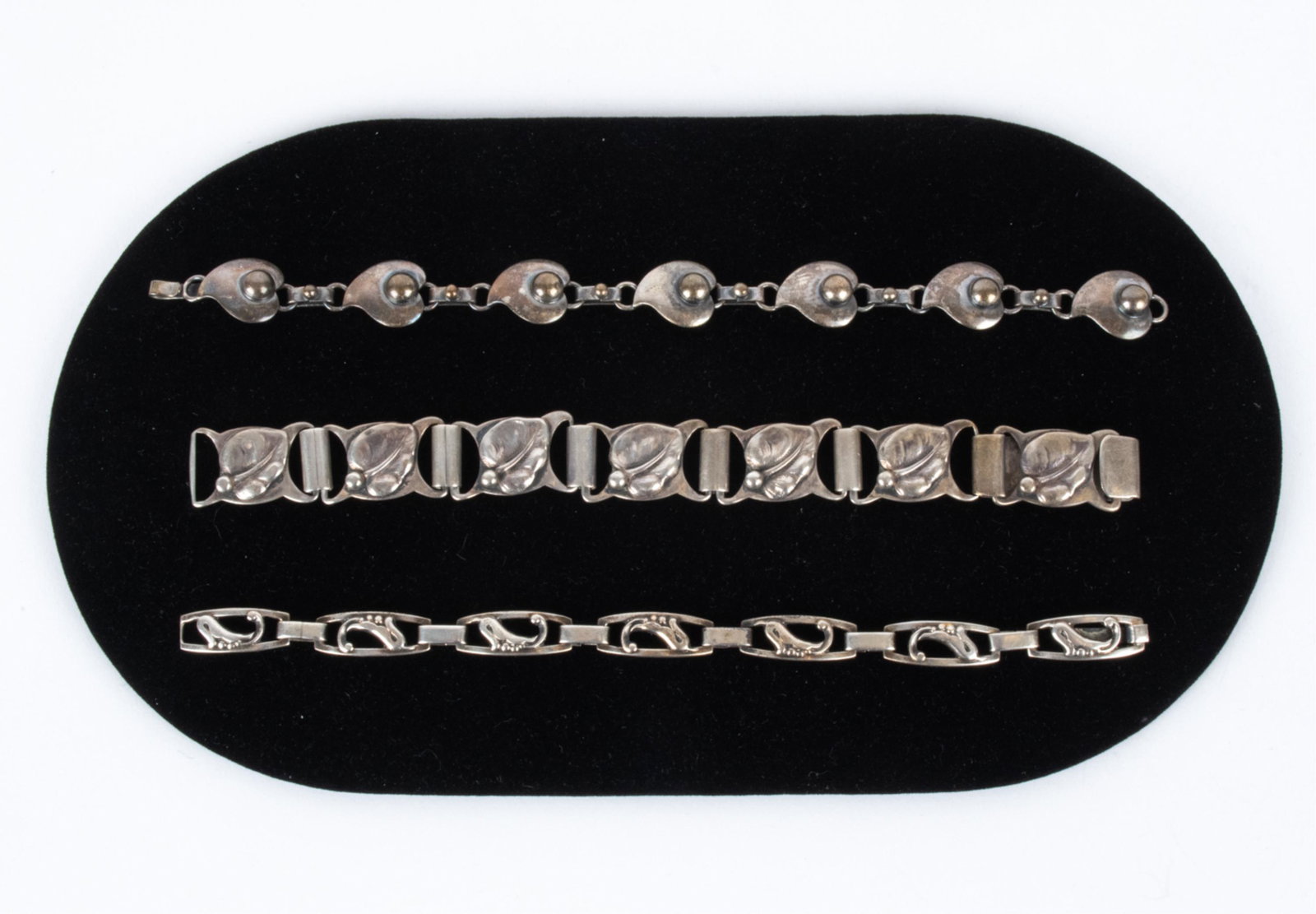 (3) RETRO SCANDINAVIAN BRACELETS; 830-925 SILVER: Grouping of (3) Scandinavian Modernist link bracelets, including: 830 silver bracelet with leaf and pea motif, signed V.P.; 830 silver bracelet with flower motif, signed E&M; and 925 silver bracelet b