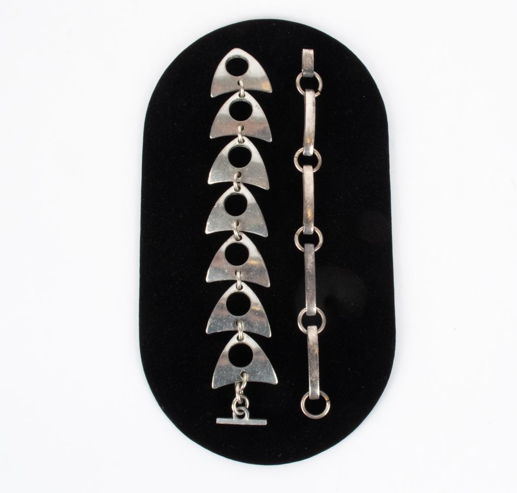 (2) DANISH MODERNIST LINK BRACELETS, 1950'S-1970'S: Wider bracelet is pewter, signed "Mette + Finn / Aero Denmark"; skinnier bracelet is silver-plated metal, signed Erik Dennung. Dimensions: (Wider) L 7.5" x W 1.25" Condition: Patina and surface wear i