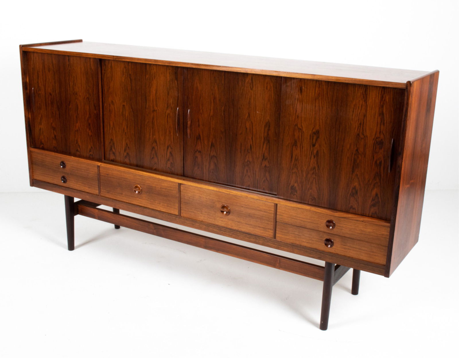 ATTR. ARNE VODDER DANISH ROSEWOOD SIDEBOARD: Danish mid-century highboard in rosewood, attributed to Arne Vodder. No apparent labels. Dimensions: H 43" x W 79" x D 17.5" Condition: Some fading to lower drawers. Couple scattered marks and light s