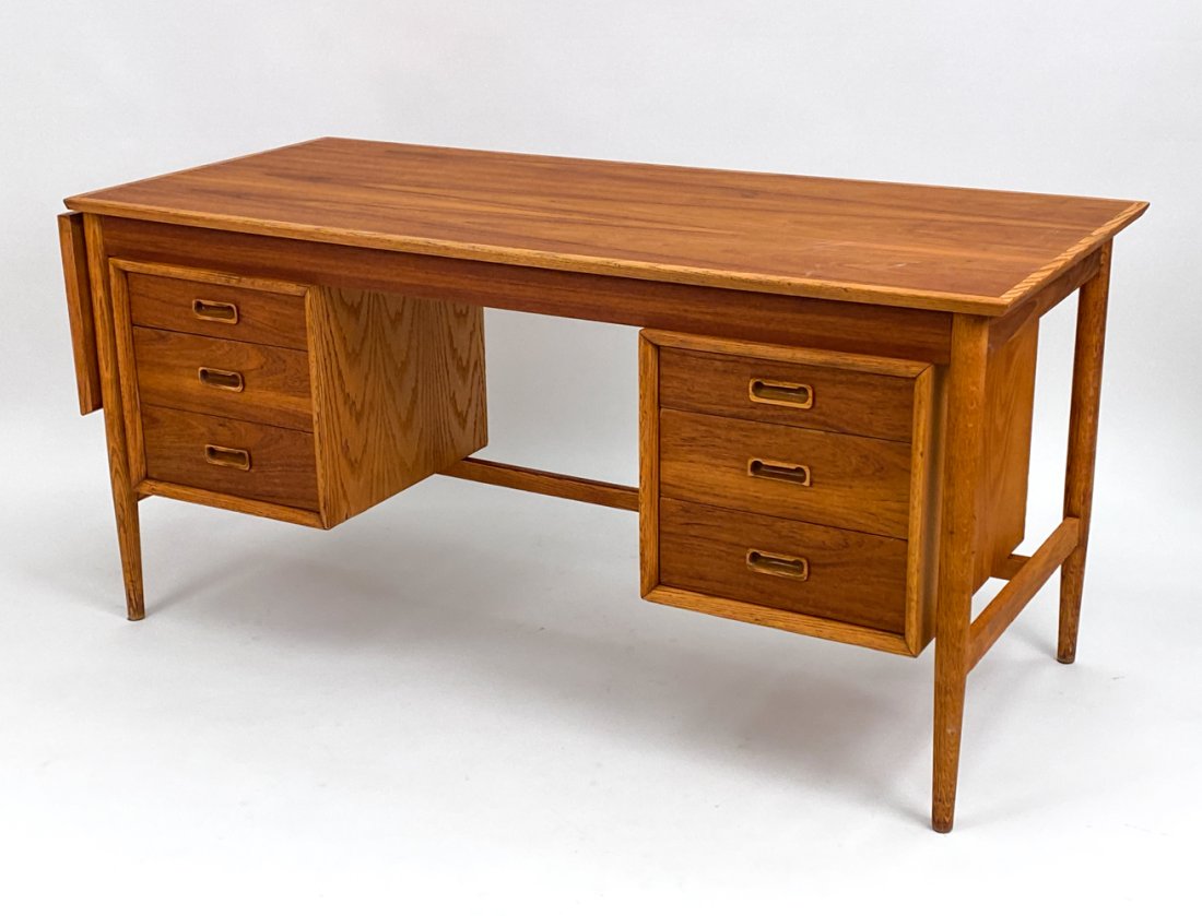MID-CENTURY DROP LEAF DESK STYLE OF ARNE VODDER: Great Mid-Century Modern drop leaf executive desk in the manner of Arne Vodder. Features a single drop leaf, sculpted handles and file drawer. Dimensions: H 29.5" x W 61.75" x D 27" Condition: Surface