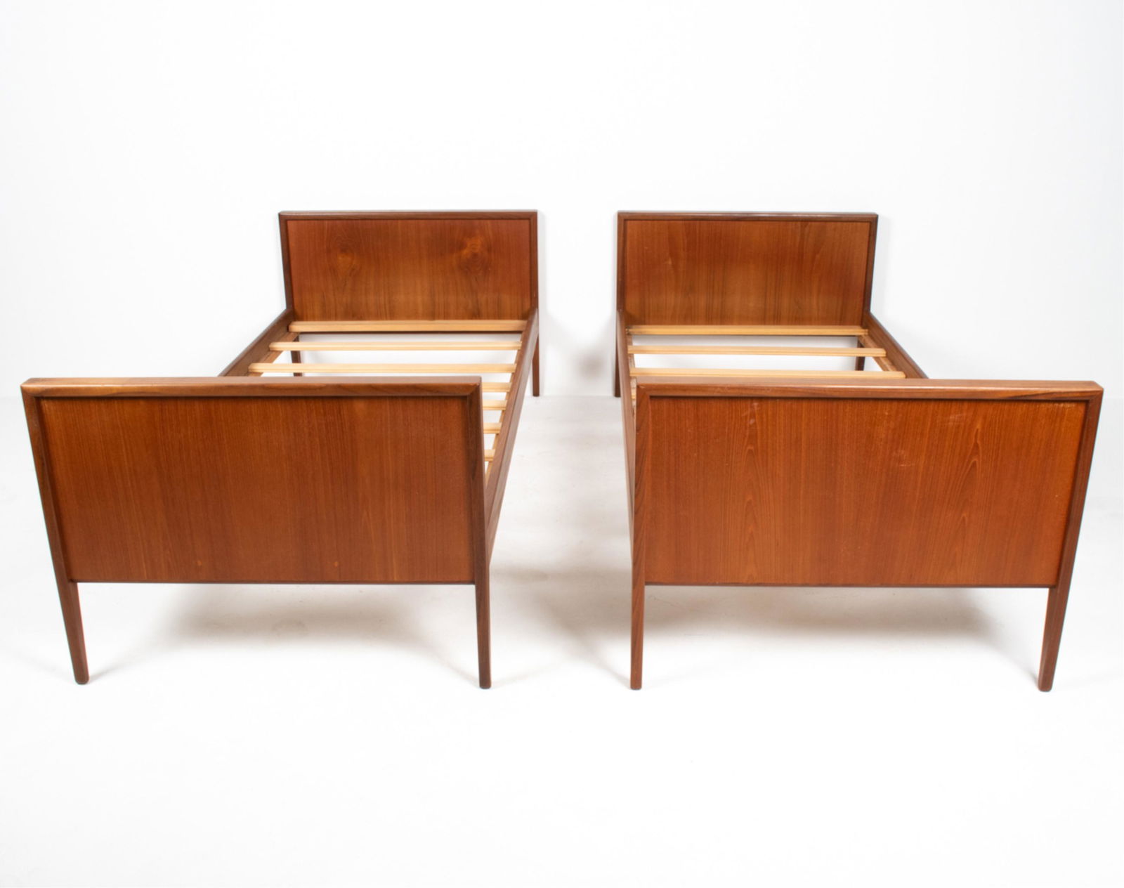 PAIR OF DANISH MID-CENTURY TWIN DAYBEDS: Dimensions: (Exterior) H 21" x W 35.5" x D 77.75"; (Interior, for mattress) W 33" x D 74.5" Condition: Sun fading, a few spots of water soiling; dings and scuffs. Wear consistent with age and use. C09