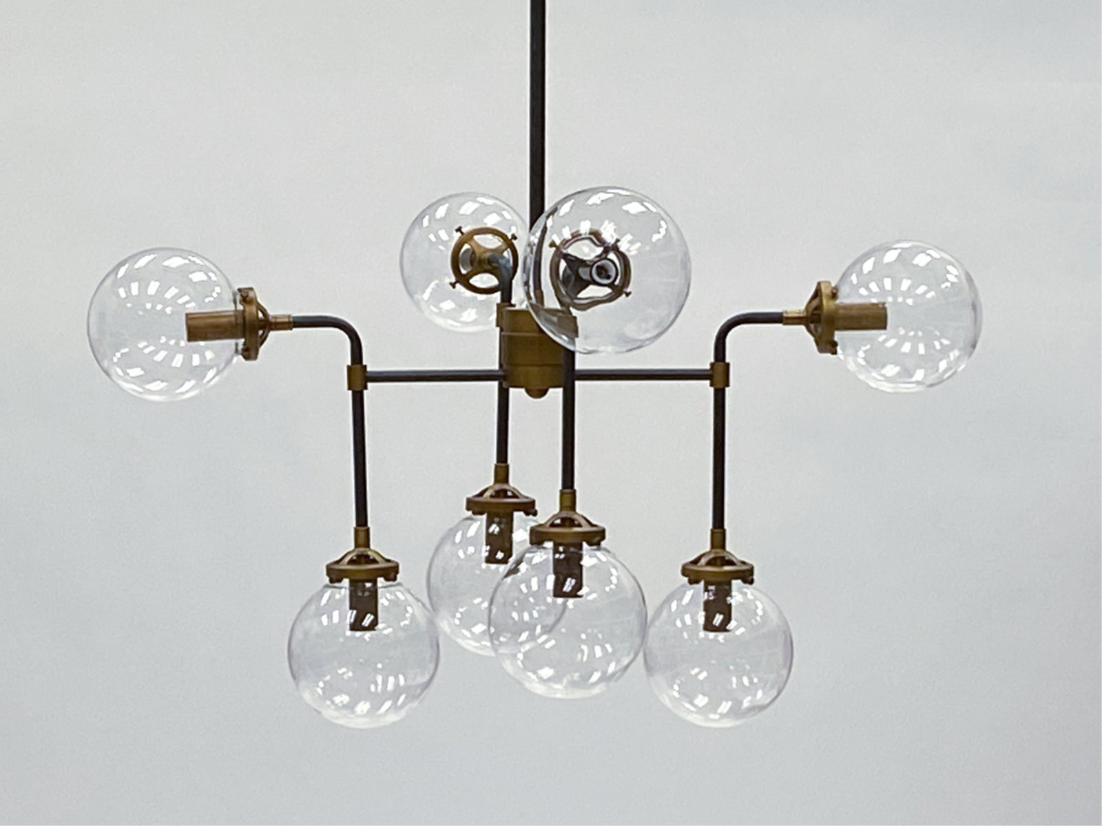 CONTEMPORARY 8-LIGHT GLOBE SHADE CHANDELIER: Clear globe shades. Dimensions: H 58" x W 34" x W 34" Condition: Untested. Light signs of handling. Couple very small light scratches.