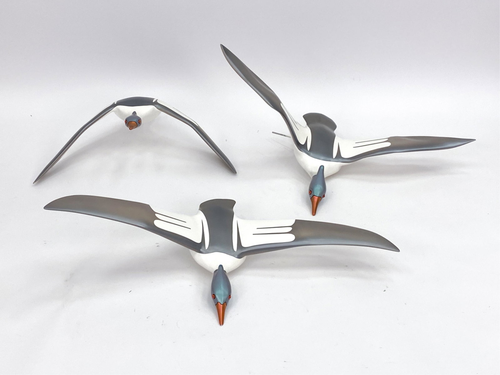 (3) CONTEMPORARY FIBERGLASS DUCK SCULPTURES: Ducks in flight. Apparently unmarked. (3) merganser ducks rendered from high density urethane foam polymer using multi axis 3D carving tools. Originally purchased for $16,800 from Timothy Hochstetter 