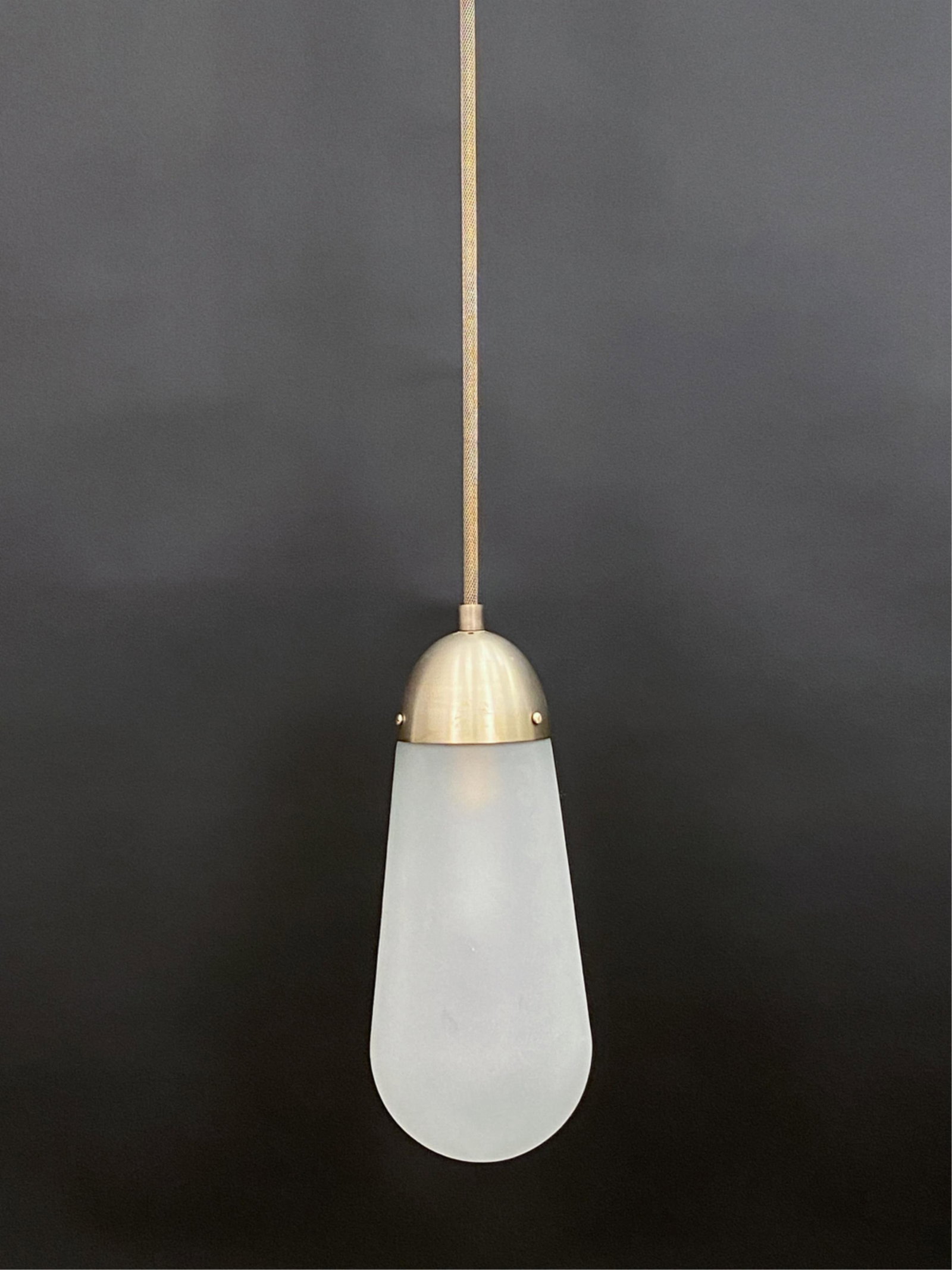 GABRIEL HENDIFAR, APPARATUS "LARIAT" PENDANT LIGHT: With Apparatus label to canopy. Frosted glass shade. Designed by Gabriel Hendifar for Apparatus. Dimensions: (Fixture) H 15" x Dia. 6" Condition: Very light signs of handling. Untested.