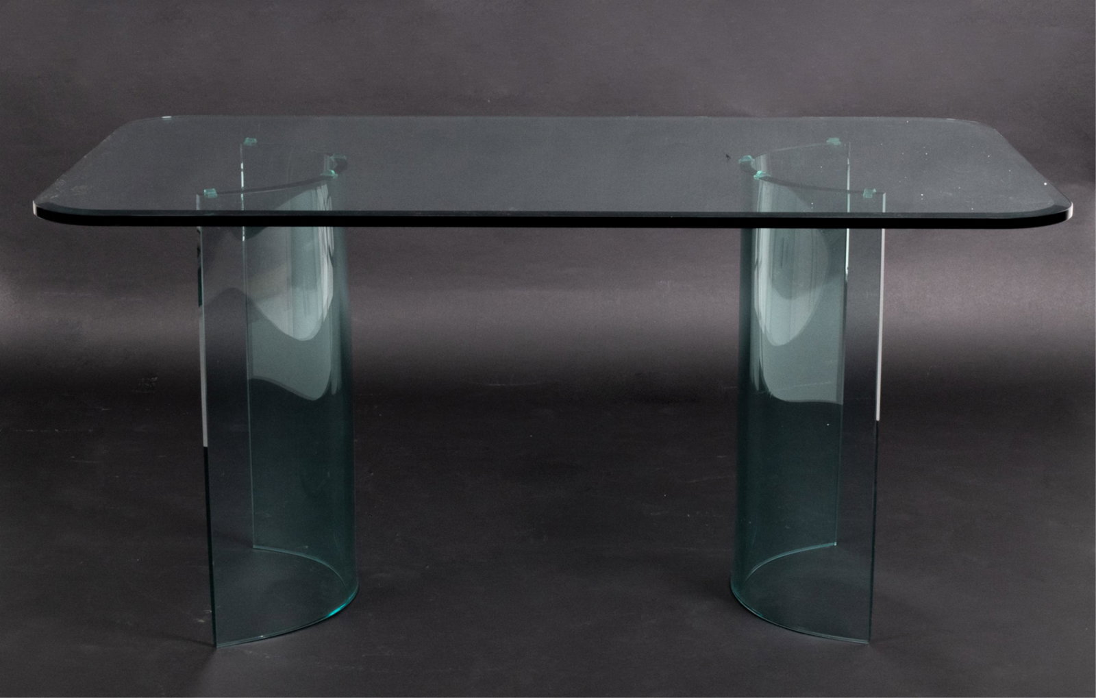 POSTMODERN SCULPTURAL GLASS DINING TABLE: From the Carousel series by Glass Art Classic. Dimensions: H 29" x W 60" x D 36" Condition: A couple very faint surface scratches; no signs of chips or cracks to glass.