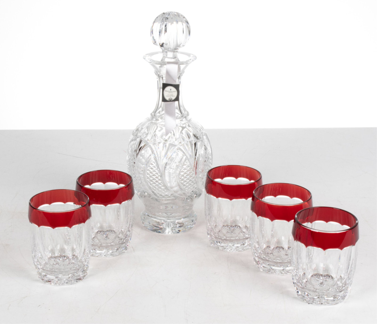 WATERFORD CRYSTAL DECANTER & TUMBLERS: Incuding: "Seahorse" cut crystal wine decanter and (5) double Old Fashioned glasses from the "Simply Red" pattern. Each piece signed with acid-etched mark underneath; decanter with original box. Dimen