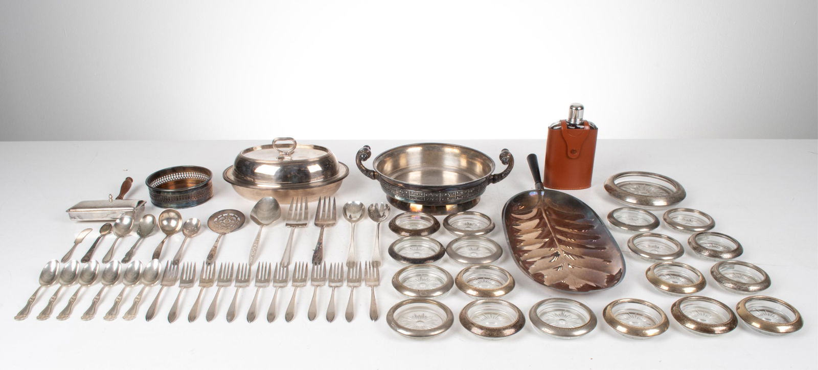GROUPING OF SILVERPLATE TABLEWARE & BARWARE: Dimensions: (Largest, leaf-form tray) H 2.5" x L 21" x W 8" Condition: Showing various signs of wear consistent with age and use; surface tarnish, dings and dents, some rubbing and loss to silver plat