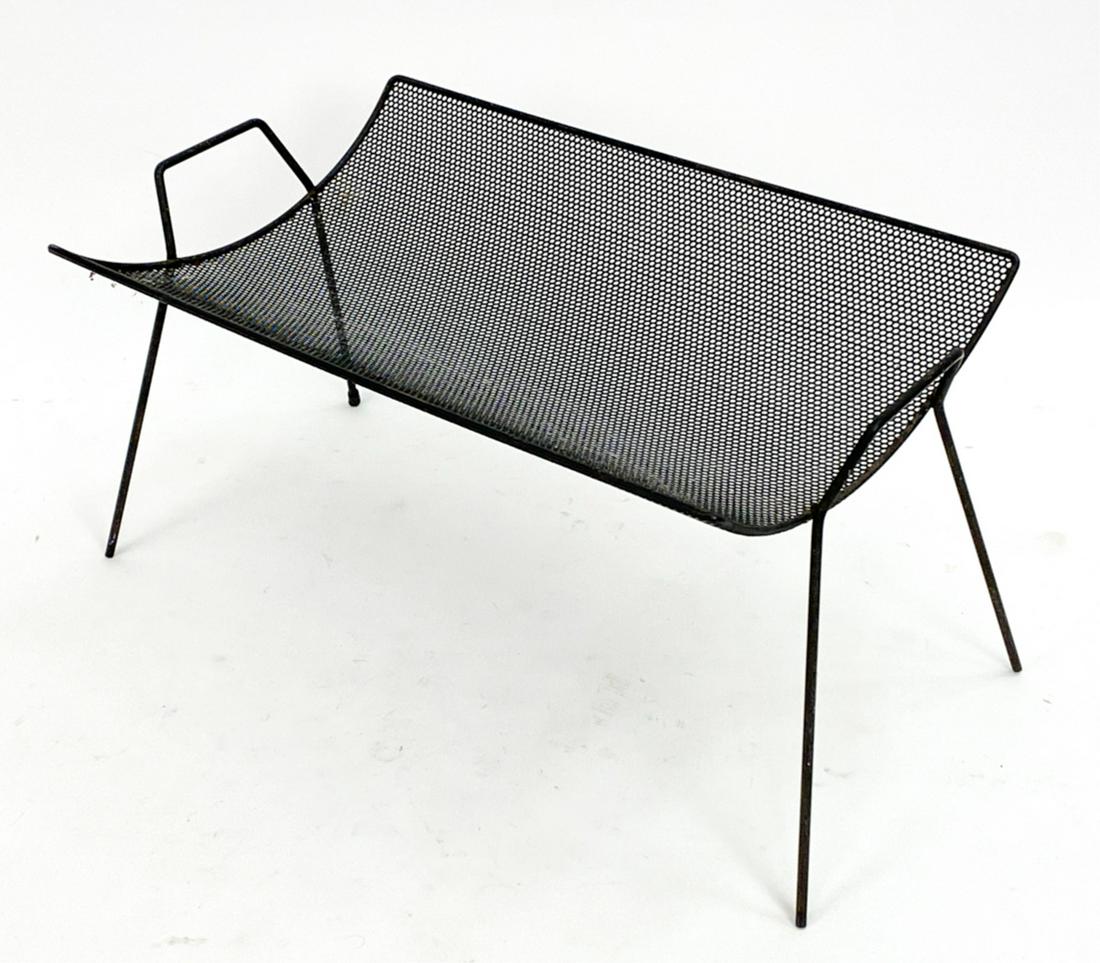 RICHARD GALEF PERFORATED METAL MAGAZINE RACK: Perforated metal catch all or magazine cradle by Richard Galef for Ravenware. Distributed by Raymor, USA c.1950s. Dimensions: H 14.25" x W 29" x D 16.25" Condition: Minor surface wear, rust, dust cons