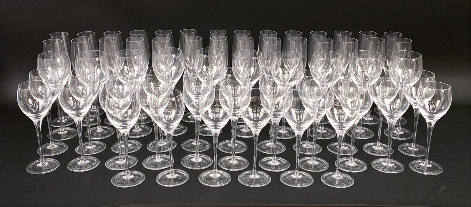 ROSENTHAL STEMWARE: Signed. Includes 28 flutes, 10 9.5" wine glasses, and 28 8.5" wine glasses. Dimensions: (Tallest) H 10" x D 2.75" Condition: Showing signs of use including a couple with flea bites to rims.