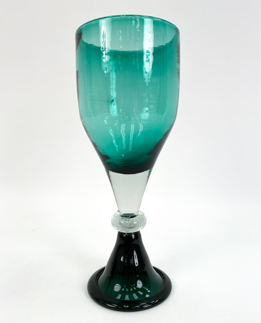 WAYNE HASTED FOR BLENKO GOBLET: Green and clear glass goblet, with artistic swirl pattern in bowl of glass. Signed Blenko underneath. Dimensions: H 11" x Dia 4.25" Condition: No issues to note.