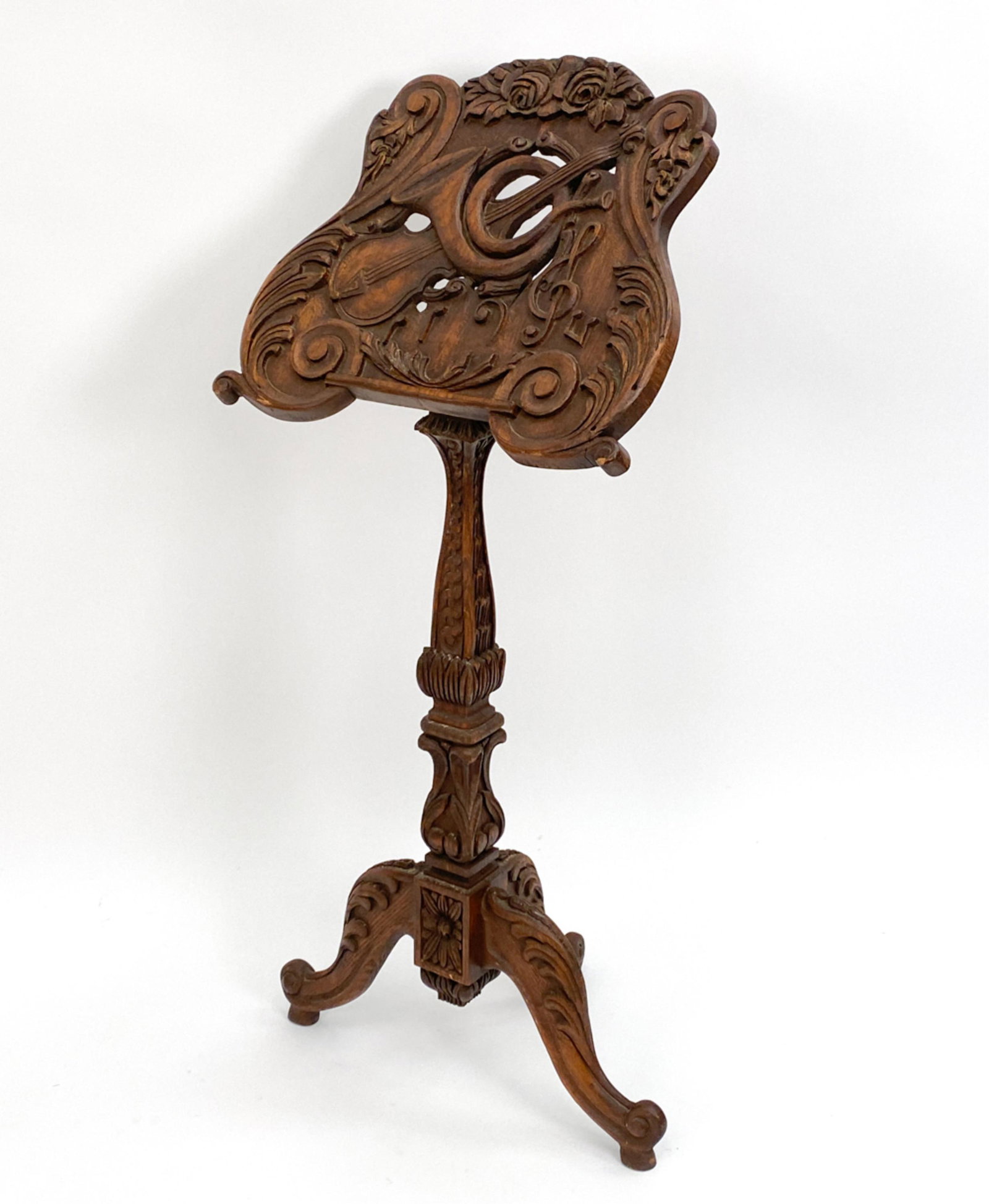 ANTIQUE CARVED MUSIC STAND: Carved oak with baroque motifs. Dimensions: H 50" x W 24" x D 13" Condition: Some tight splits. Some nicks and rubbing to the edges. Top somewhat loose on stand.