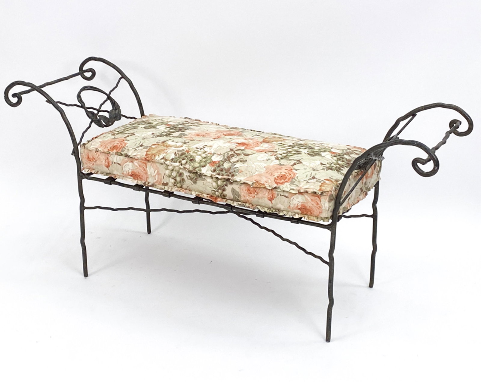 IRONIES WROUGHT IRON BENCH W/ BENNISON CUSHION: Bent twig form iron with faux aged patinated surface. With Bennison fabric cushion. Dimensions: H 29" x W 62.5" x D 18" x SH 20.5" Condition: Some fading to the cushion.