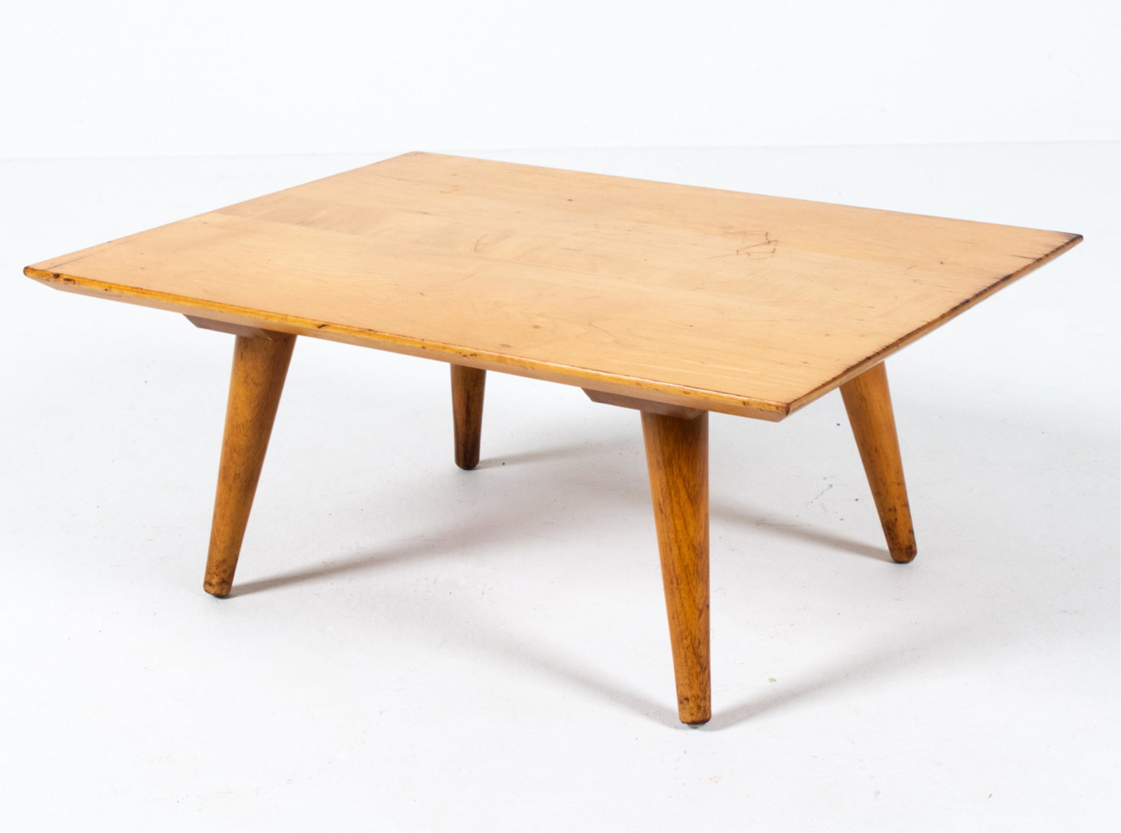 ATTR. PAUL MCCOBB PETITE BLONDE WOOD ACCENT TABLE: Petite coffee table or bench. Dimensions: H 10" x W 24" x D 18.25" Condition: Dark wood stain to edges; several gouges to top. Scattered nicks, dings and scuffs throughout.