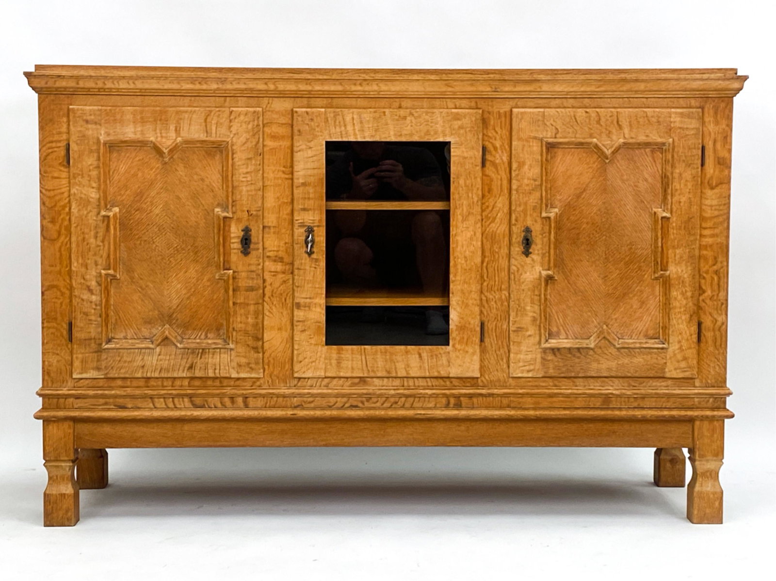 HENNING KJAERNULF-STYLE DANISH OAK SIDEBOARD: Including key. Unsigned. Dimensions: H 38.75" x W 59.75" x D 18" Condition: Areas of finish wear consistent with age and use. Couple water marks to uppermost surface. Some wear to some corners and edg