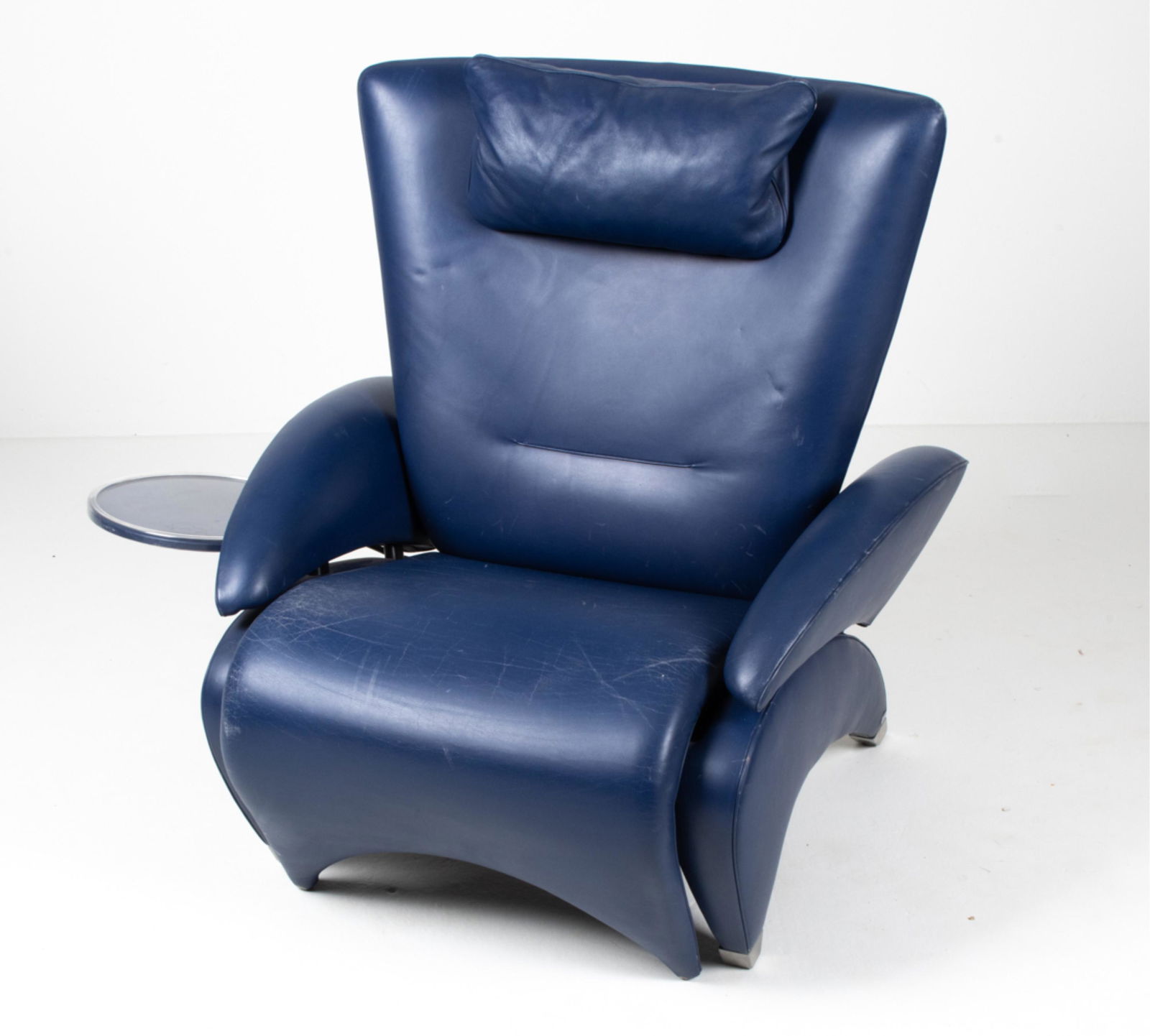 DE SEDE MODEL DS -260 BLUE LEATHER LOUNGE CHAIR: Postmodern Avant-Garde lounge chair by De Sede in dark blue leather and brushed metal, featuring an integrated pull-out footrest and attached side table. C. Late 20th-Early 21st Century. Dimensions: (