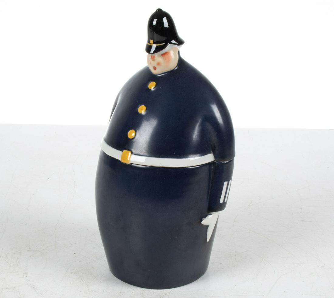 ROBJ FRENCH PORCELAIN POLICE CONSTABLE JAR: Bonbonniere or biscuit jar in the form of a rotund police officer; signed Robj Paris underneath, c. Early- to Mid-20th Century. Dimensions: H 10" x W 5.25" x D 4.5" Condition: One tiny naturally-occur