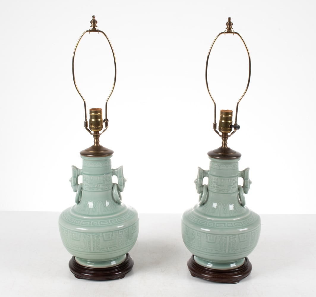 PAIR OF CELADON PORCELAIN LAMPS: Dimensions: H (to finial) 26" x Dia. 9" Condition: Wiring not tested. No signs of chips or cracks to porcelain. Patina to metal, a few rubs to stands.