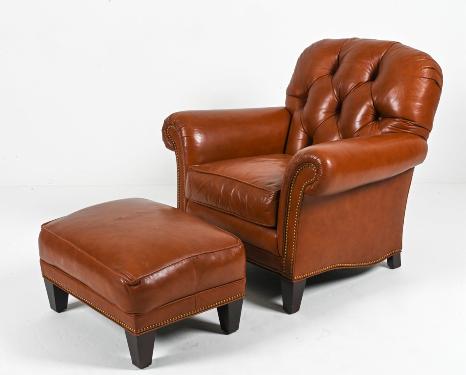 BRUNSCHWIG & FILS LEATHER CLUB CHAIR & OTTOMAN: Labeled underneath. Dimensions: (Chair) H 36" x W 38.5" x D 37" x SH 19.5" ; (Ottoman) H 14.5" x W 26" x D 20" Condition: In very good- to excellent used condition overall; a few scuffs and small mark