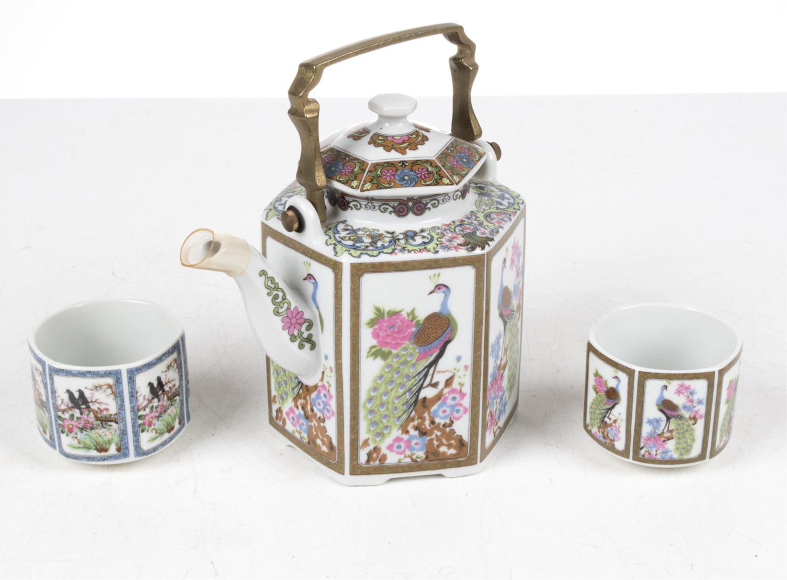 CHINOISERIE PORCELAIN TEAWARE GROUPING: Impressed letter "N" under teapot. Dimensions: (Teapot) H 7.5" x W 7.5" x D 6.5" Condition: Light patination to teapot handle, blue marks to interior of one cup. No signs of chips, cracks or repairs.