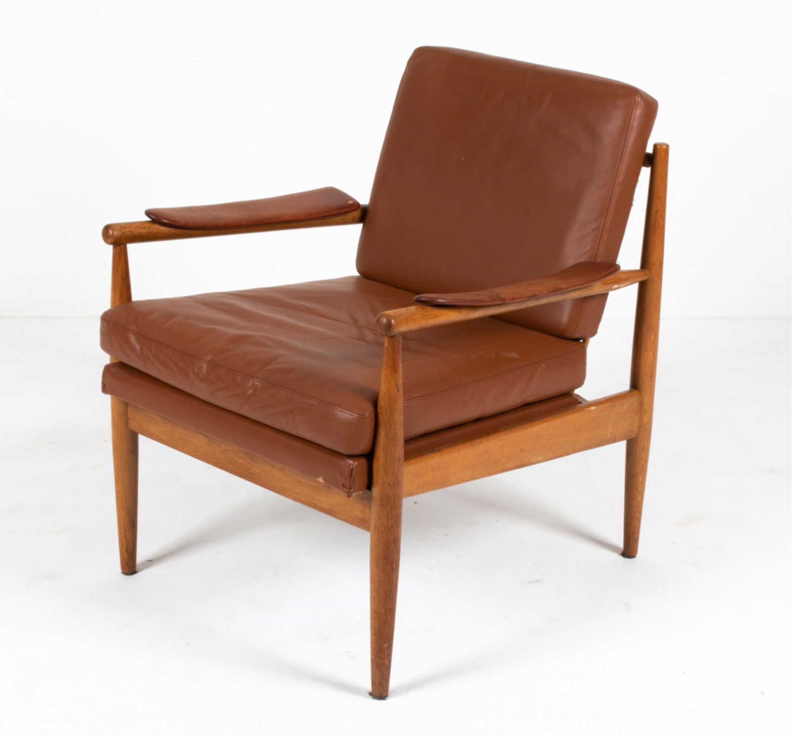 SCANDINAVIAN MID-CENTURY LOUNGE CHAIR: Style of Arne Vodder or Finn Juhl. Dimensions: H 31.5 " x W 25.5 " x D 28" x SH 18" Condition: Nicks and dings to wood, a few small chips; patina and wear to upholstery. PA105