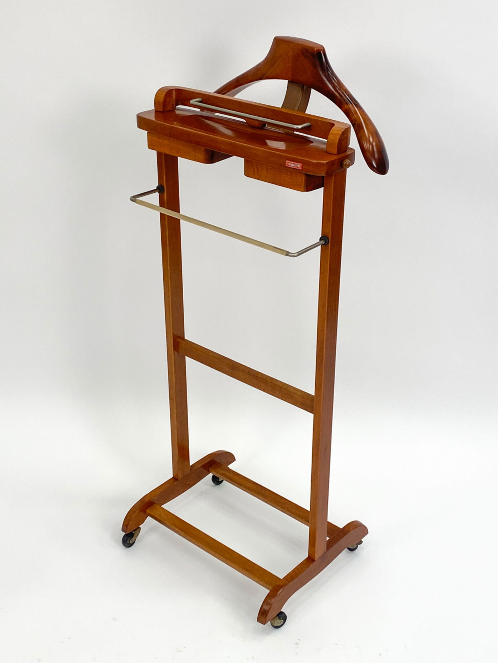 FRATELLI REGUITTI ITALIAN MID-CENTURY VALET: Fine Italian gentleman's rolling valet. Stained beech, steel, plastic. Circa 1960s. Plastic Reguitti manufacturers tag on frame. Dimensions: H 41.5" x W 17" x D 13.75" Condition: Minor surface wear, s