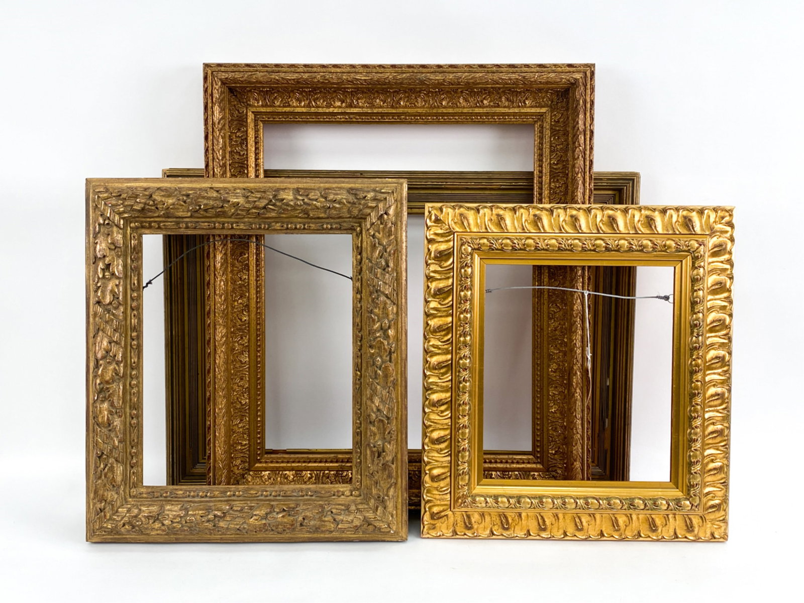 (4) ATTRACTIVE GOLD FRAMES: Including one reeded antique and three modern. Dimensions: (Largest, overall) H 30.5" x W 27" Condition: A few edge rubs. Antique frame with some losses.