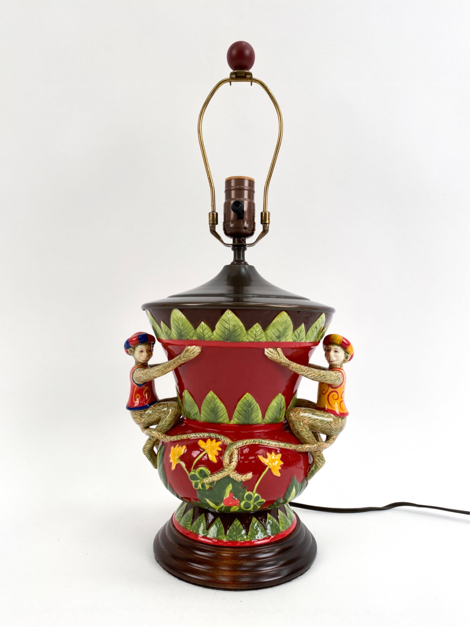 CONTEMPORARY GLAZED MONKEY VASE, AS LAMP: Majolica-style, with two monkeys mounted as handles. Dimensions: (To finial) H 20.5" x W 9.25" x D 7.75" Condition: Showing light signs of handling including a ding to metal top.