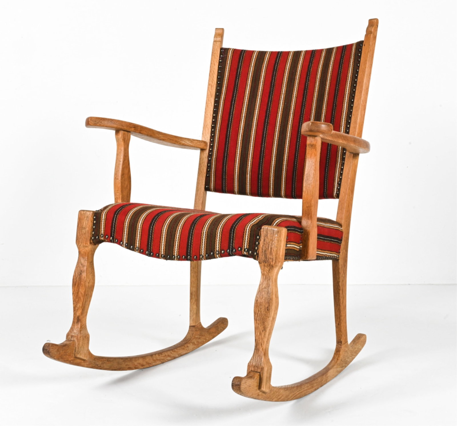 ATTR. HENNING KJAERNULF DANISH OAK ROCKING CHAIR: Dimensions: H 37" x W 27.5" x D 30.5" x SH 16.5" Condition: Frame showing minor joint separation, right arm slightly loose; wood with a few water spots and spots of soiling. Surface dust and a few sma