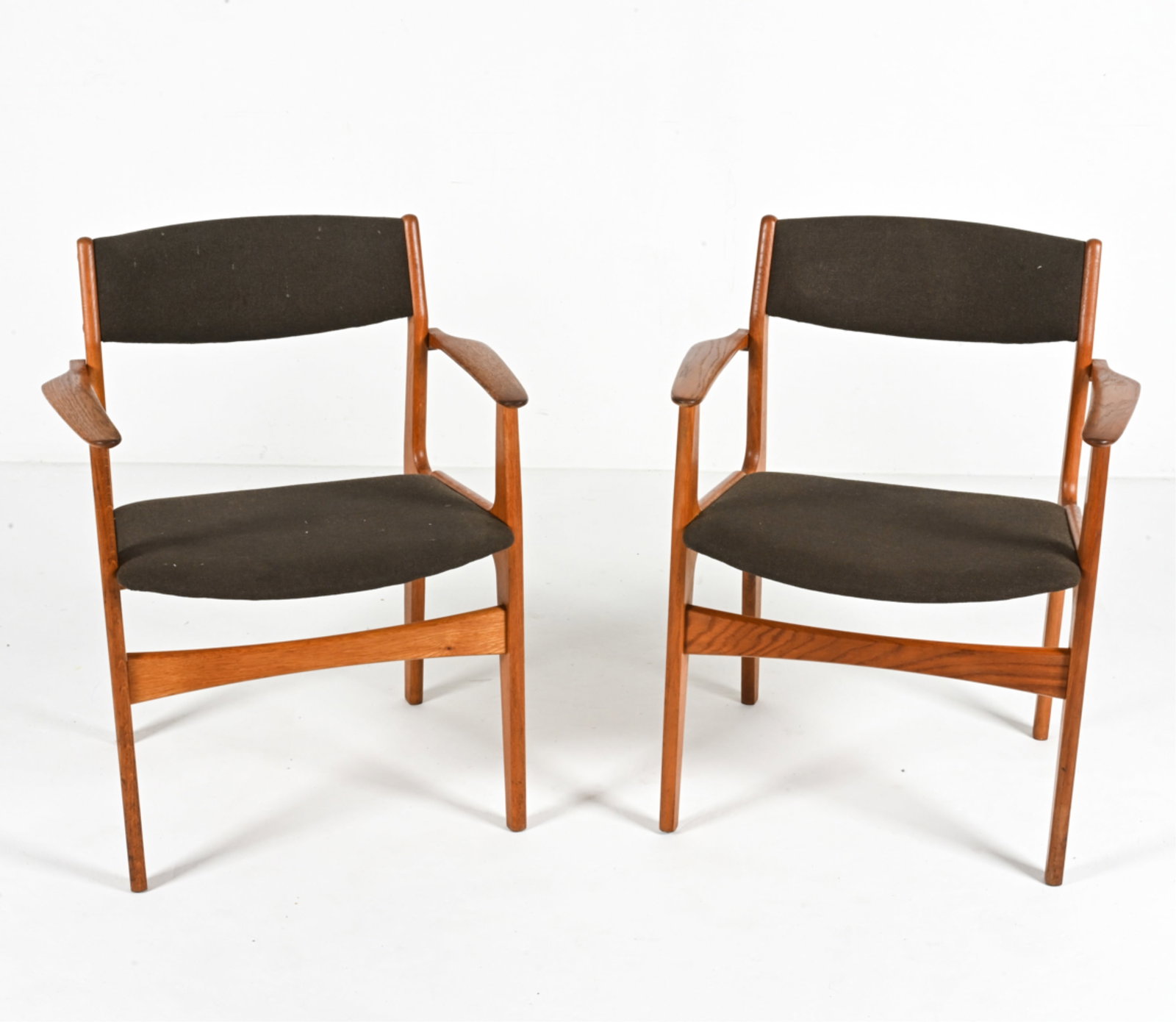 PAIR OF DANISH OAK ARMCHAIRS BY NOVA MOBLER: Labeled Nova Mobler underneath, c. 1960's. Dimensions: H 30.75" x W 24.25" x D 20.5" x SH 18" Conditions: Wear consistent with age and use. Dings and scuffs, some apparent sun fading to wood. Soiling 
