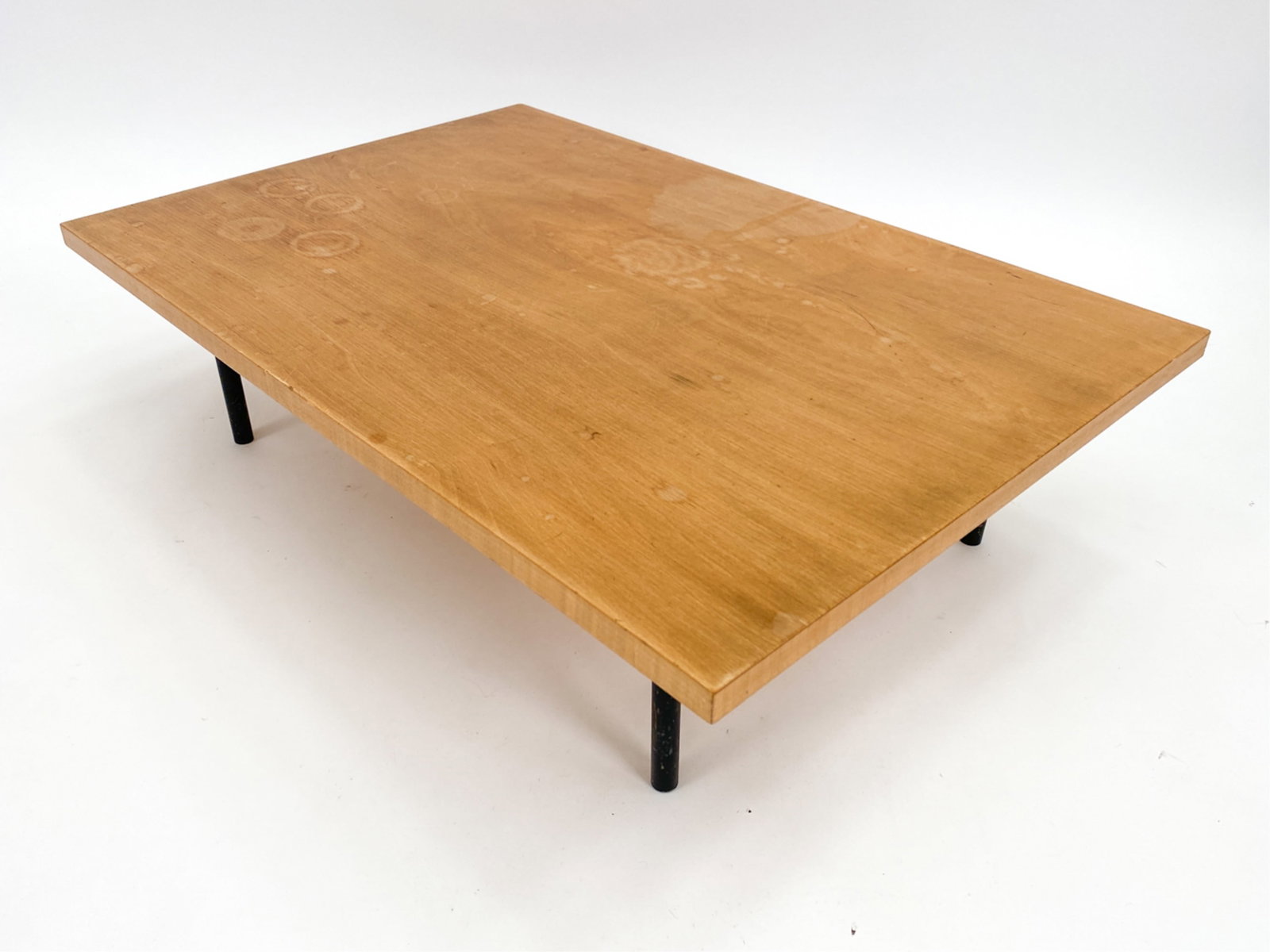 VINTAGE MODERN LOW TRAPEZOID SIDE TABLE: Vintage Modern low wood side table with metal legs. Apparently unmarked. Dimensions: H 9" x W 35" x D 23" Condition: Surface wear consistent with age and use. Ring marks to top.