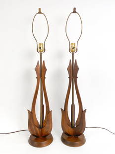 MID-CENTURY SCULPTURAL WOOD & BRASS TABLE LAMPS: Pair of tall Mid-Century Modern sculpted wood and brass table lamps in the manner of Adrian Pearsall. Dimensions: (To finial) H 37" x Dia 7.25" Condition: Minor surface wear and tarnish consistent wit