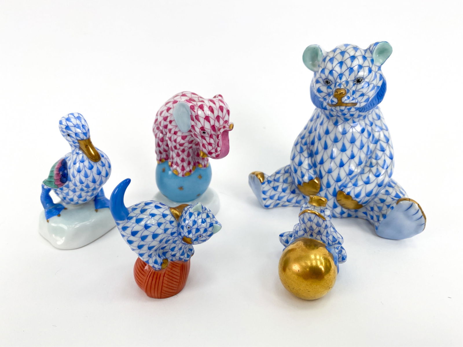 (5) HEREND FISHNET PORCELAIN ANIMAL FIGURINES: Varying sizes. Including sitting bear, cat on a ball, elephant on a ball, a duck, and a frog with a gold crown. Marked underneath. Dimensions: (Bear) H 3.5" x W 3.5" x D 2.25" Condition: Elephant with
