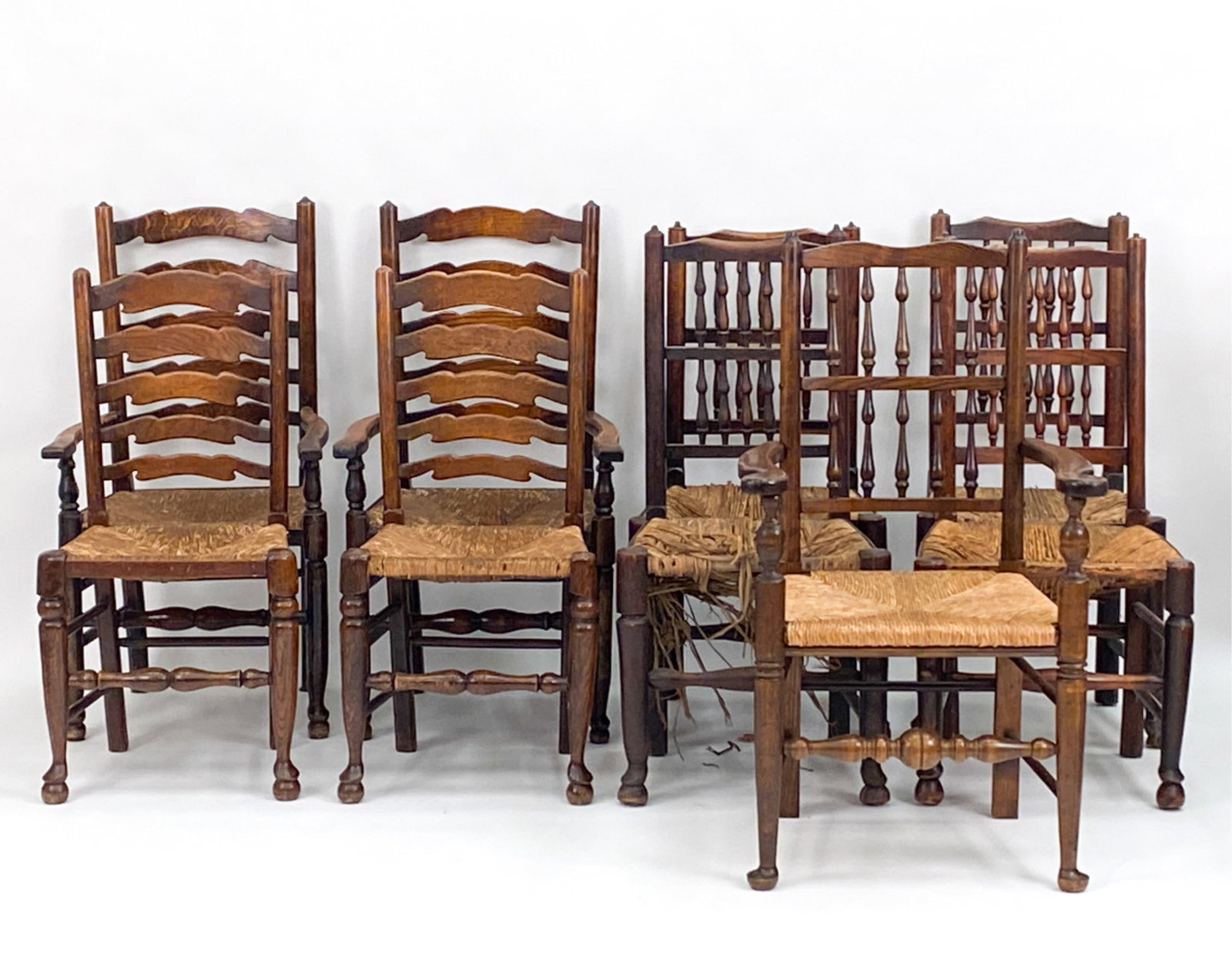 (12) 18TH/19TH C. COUNTRY OAK CHAIRS: (4) armchairs and (8) side chairs. Different styles. All with rush seats. Dimensions: (Largest armchair) H 41" x W 23" x D 21.5" x SH 20.25" Condition: Varies. Some with old surfaces, some with wear, 