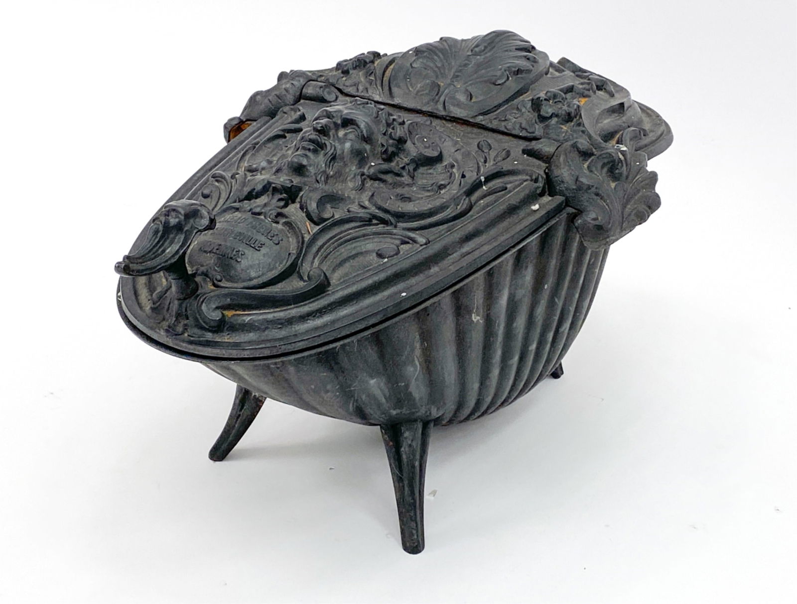 ANTIQUE FRENCH RENAISSANCE-REVIVAL COAL SCUTTLE: Iron, with highly decorative lid. Marked Corneau Freres. Dimensions: H 13" x W 22" x D 15.75" Condition: A few stray paint flecks, a little bit of rust on the exterior. Rust and use wear on the interi