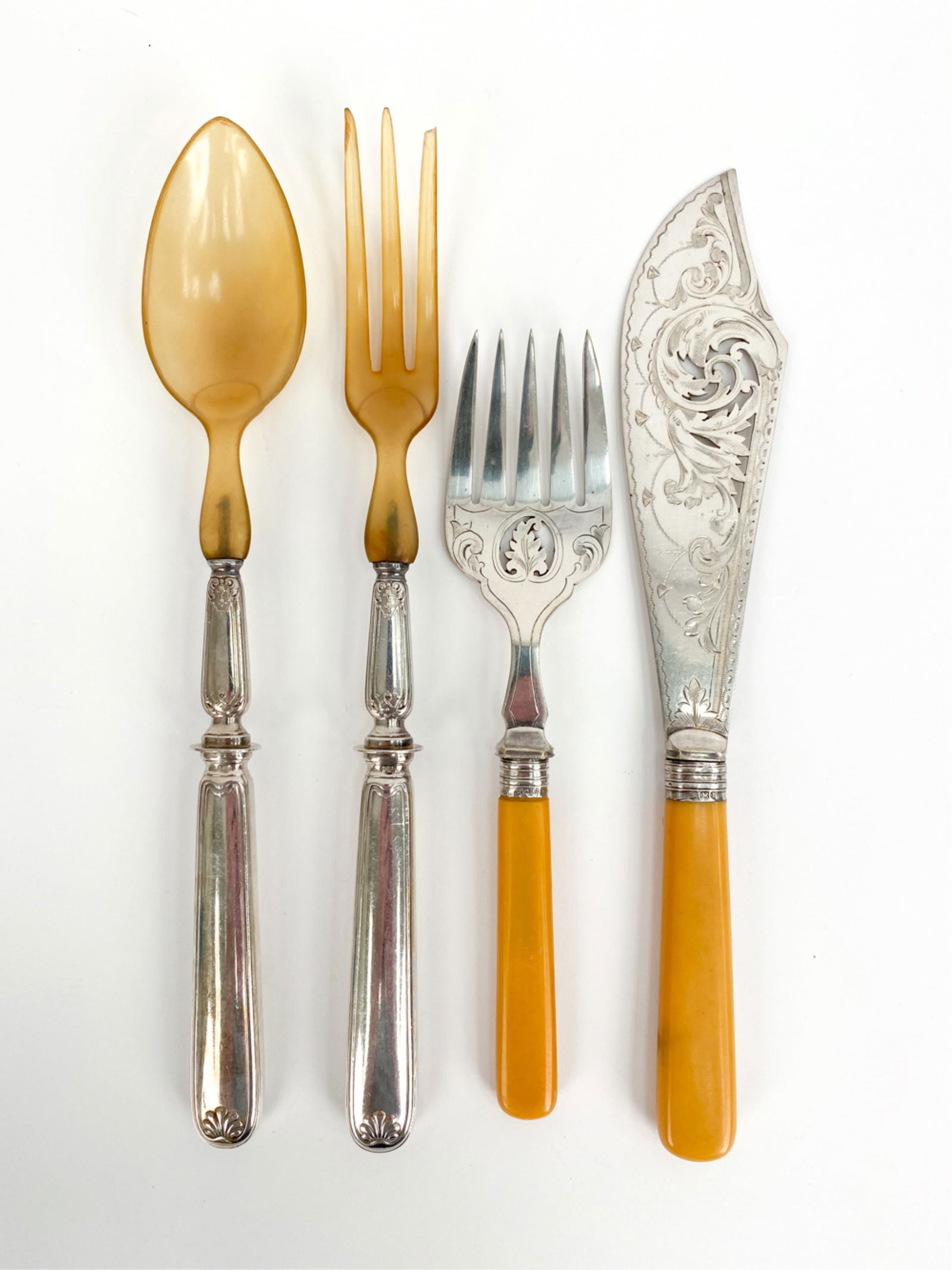 GROUPING OF STERLING-MOUNTED SERVEWARE: Including (2) pieces with Bakelite handles. Dimensions: (Long spoon) L 11.5" x W 2" Condition: Longer fork with minor chip and loss to one tine. Patina and light surface wear consistent with age.