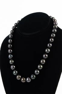 TAHITIAN CULTURED PEARL & 14K WHITE GOLD NECKLACE: Single-strand "princess length" necklace of (35) rich dark gray and black Tahitian pearls - the largest measuring approx. 13mm in diameter - fastened with a scalloped ball-style clasp of 14K white gol