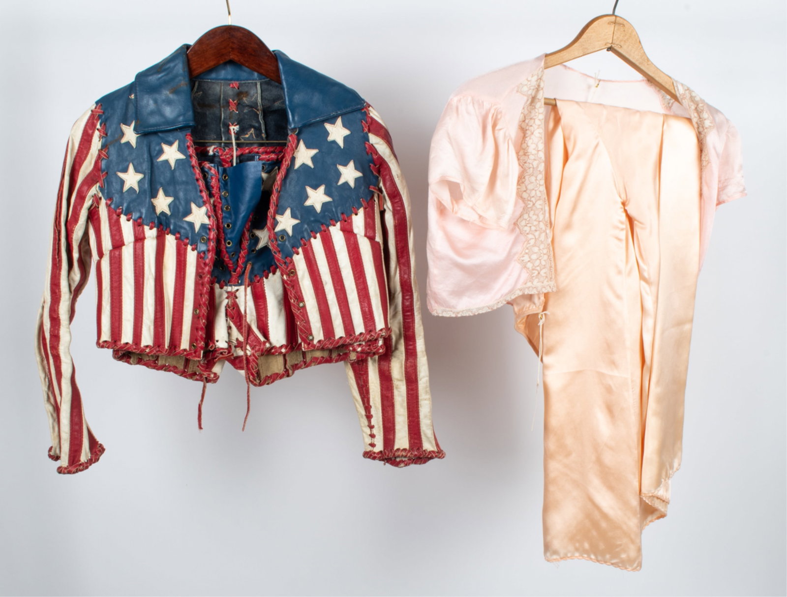 VINTAGE STAR-SPANGLED LEATHER SET & SATIN PAJAMAS: Fabulous vintage leather co-ord set consisting of a pair of high-waisted lace-front shorts and cropped lace-front shirt/jacket with allover American flag motif - shorts approx. size 27" waist, jacket 