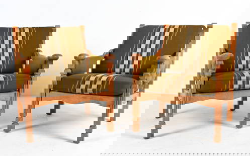 PAIR OF OAK ARMCHAIRS ATTR. TO HENNING KJAERNULF: Unusual and highly decorative pair of lounge chairs in white oak, with exposed slat backs and sculpted handrests supported by fluted stiles; finished in traditional olmer striped fabric. Attributed to
