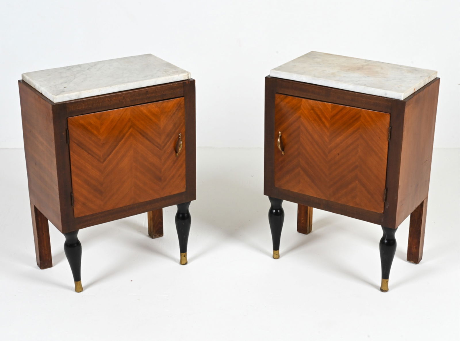 (2) MANNER OF GIO PONTI PARQUETRY NIGHTSTANDS: Pair of transitional Art Deco-Early Modern nightstands or end tables in the manner of Gio Ponti or De Coene Freres; with mahogany veneers and ebonized legs. C. 1940's. Dimensions: H 27.5" x W 18.75" x