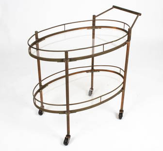 ATTR. MAXWELL-PHILLIPS TIERED BAR CART, C. 1950'S: Tiered oval bar cart in metal and glass, with removable handle. Attributed to Maxwell-Phillips of New York, c. 1940's-1950's. Metal appears to be copper or brass with high copper content. Dimensions: