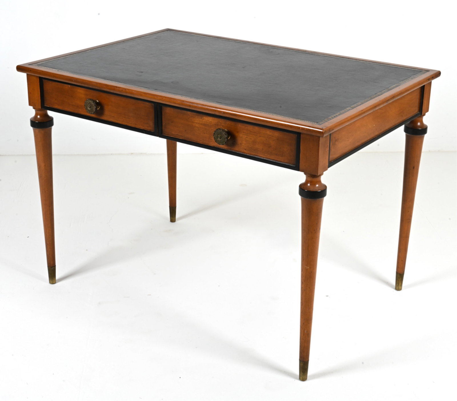LEATHER-TOP WRITING DESK WITH EBONIZED TRIM: Finely crafted two-drawer desk featuring ebonized trim and a black leather writing surface with gilt-embossed Greek Key motifs. Two false drawers on the opposite side give the appearance of a partner'